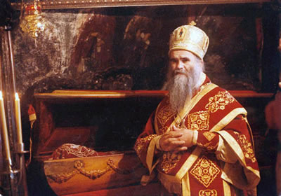 Photo of a Bishop next to the relics of a Saint.